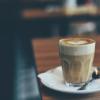 Single latte sitting on the edge of table