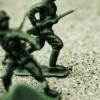 An image of toy soldiers in sand