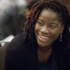 Closeup of woman smiling in conversation during conference