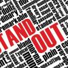 the words "STAND OUT" in red with other smaller words in black surrounding it