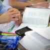 a Bible sitting open on a cluttered table