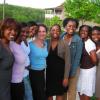 Group photo of Black and White female students in front of woods and pond