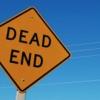 a yellow road sign reading "Dead End"